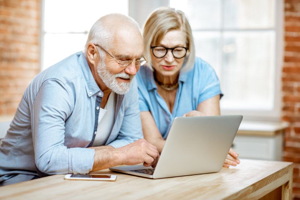 A senior couple looking at a computer together.