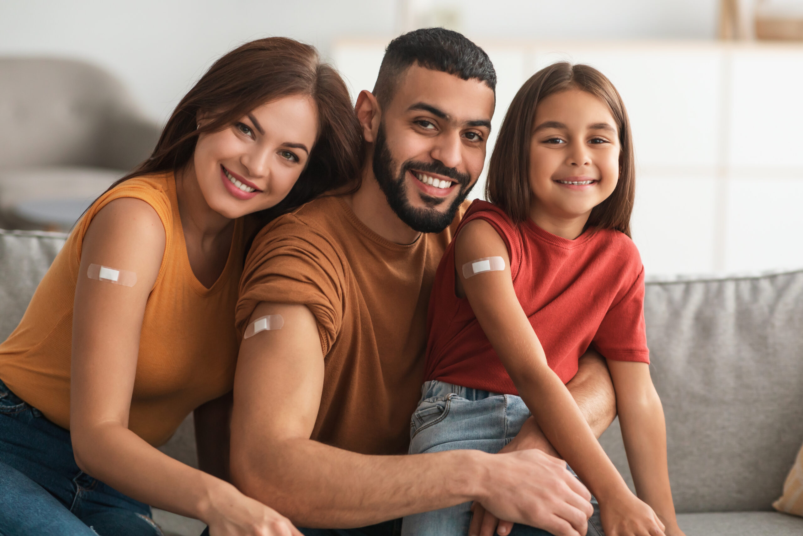 A happy family shows off bandages from a medical service.