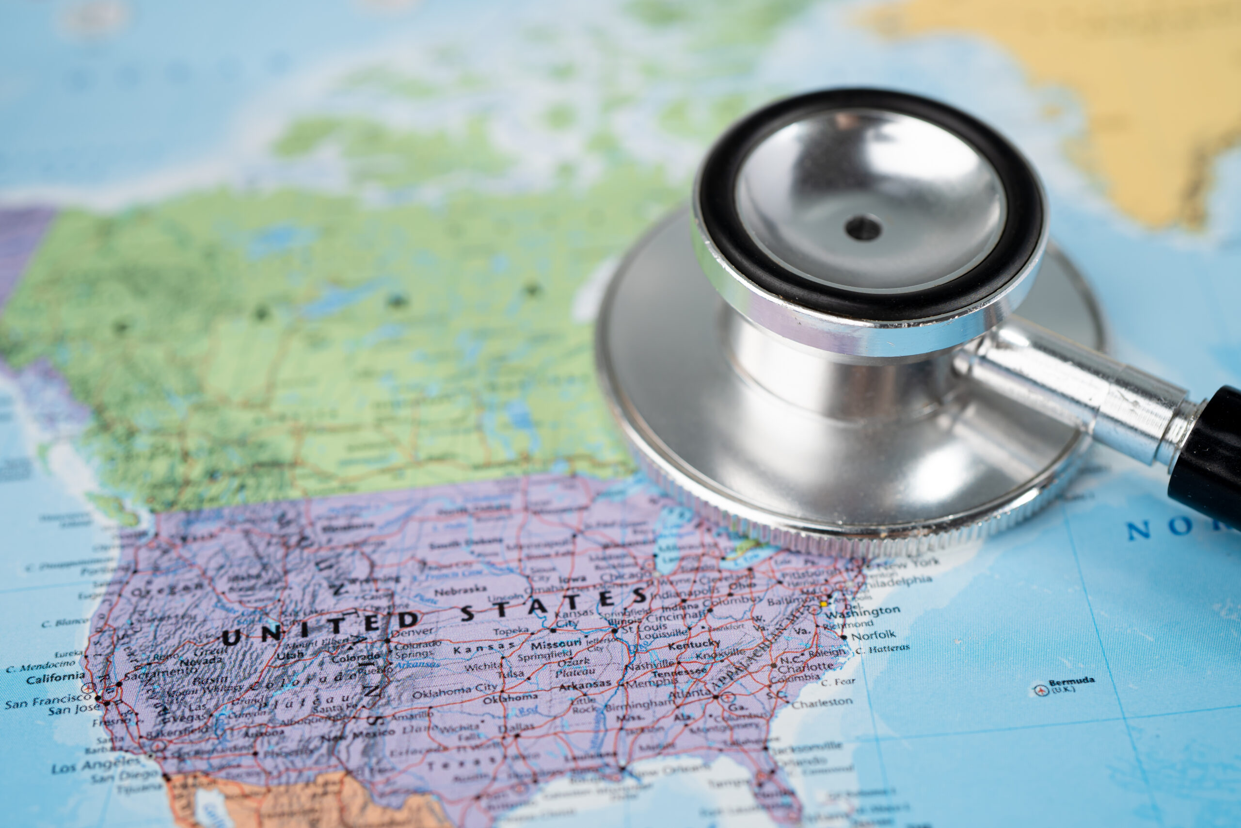 A stethoscope resting over a map of the United States.