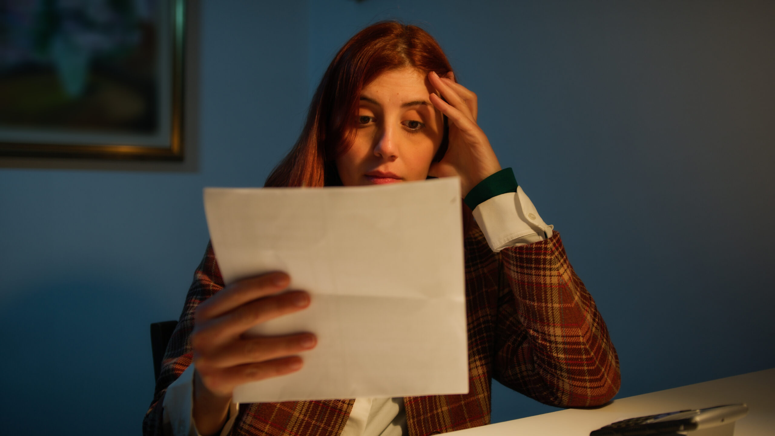 Girl reads a worrying letter.